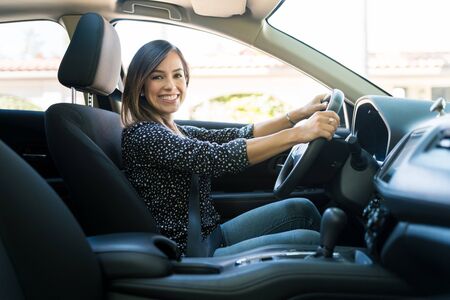 139948576 side view of smiling caucasian woman traveling in new car